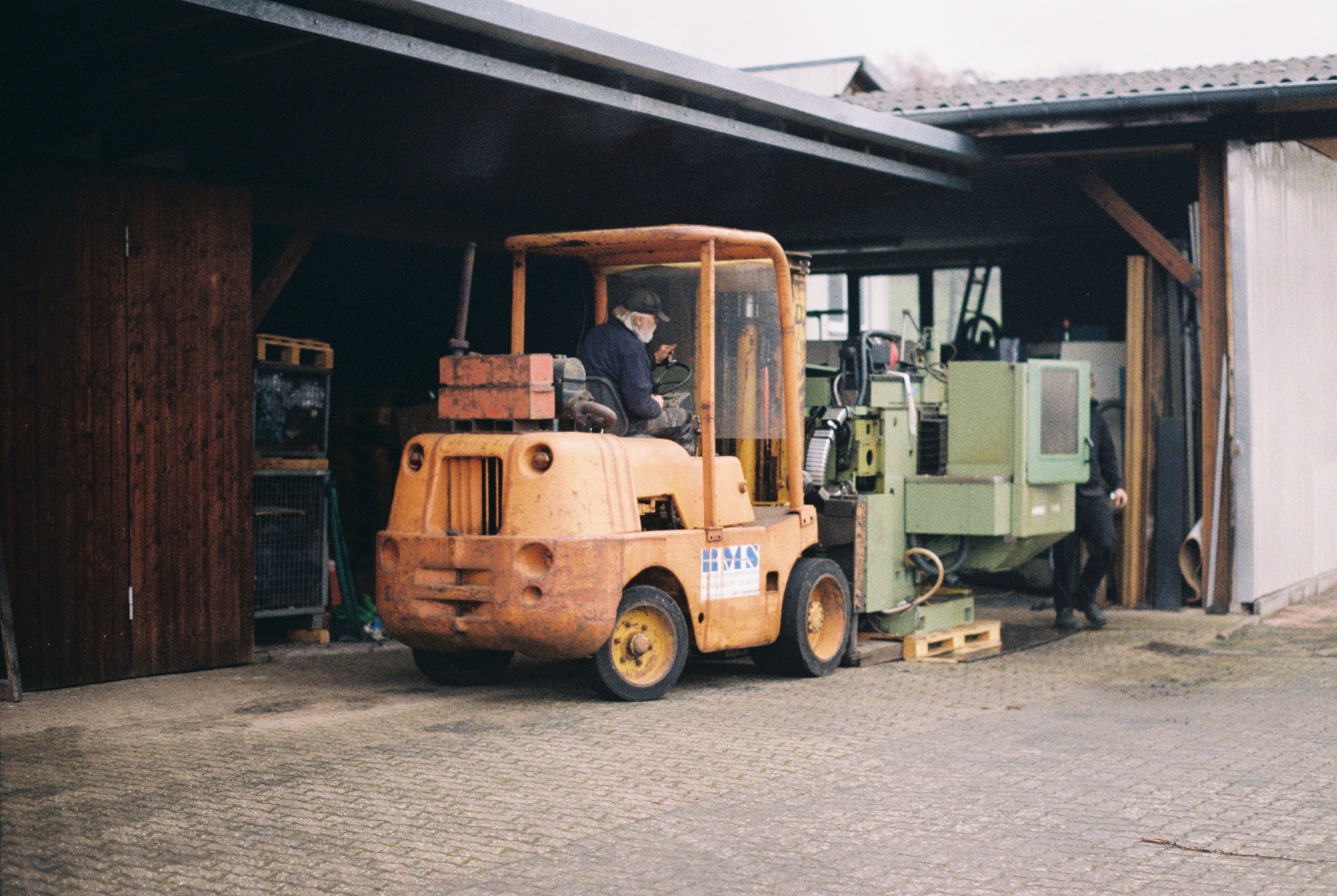 loading the machine using a 50 year old forklift and a 100 year old bavarian man