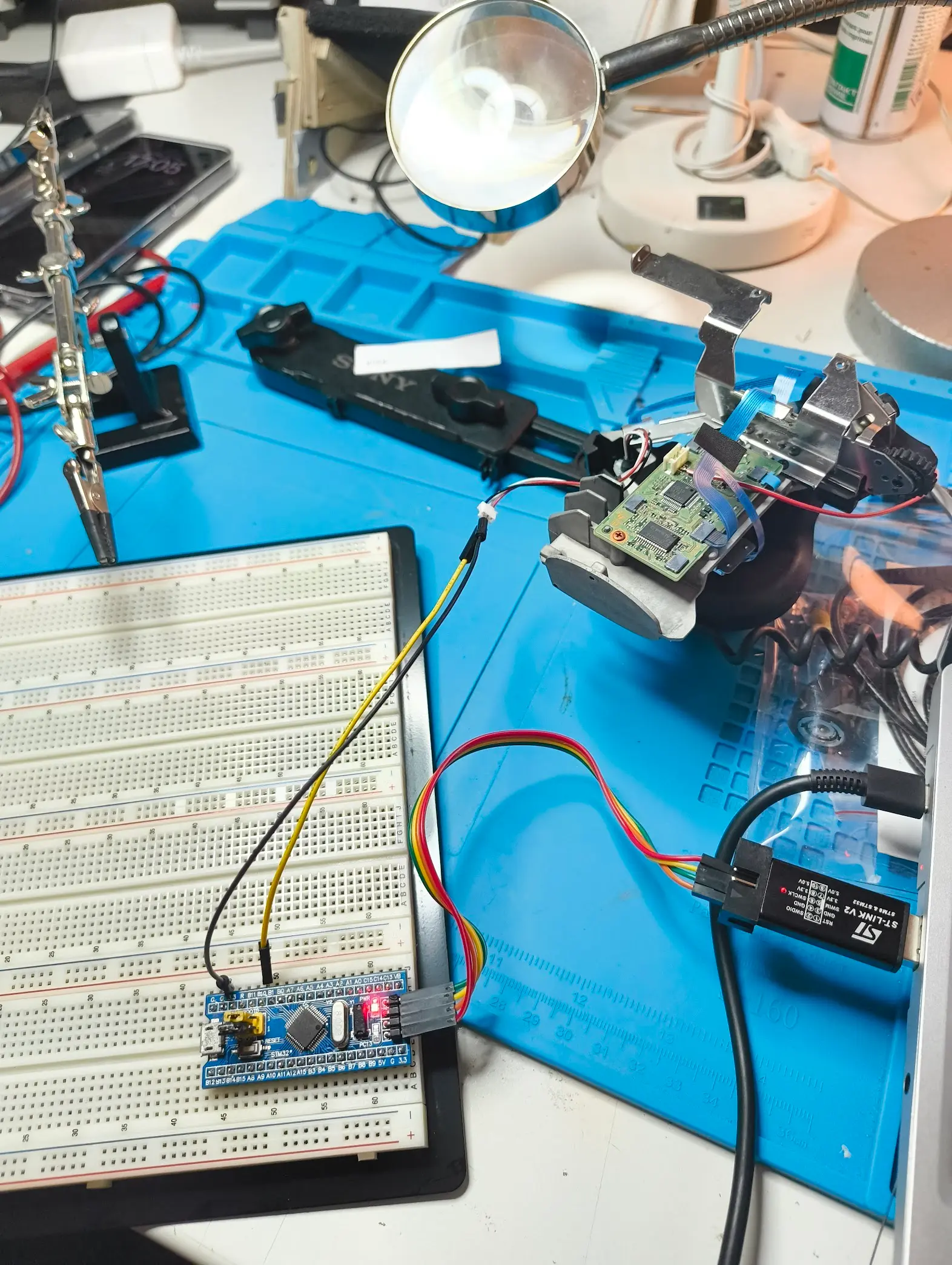 stm32f103 board with jumper wires connecting to the grip cable